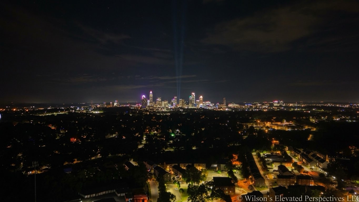 Charlotte skyline and illuminated streets at night with the Wilson’s Elevated Perspectives LLC watermark